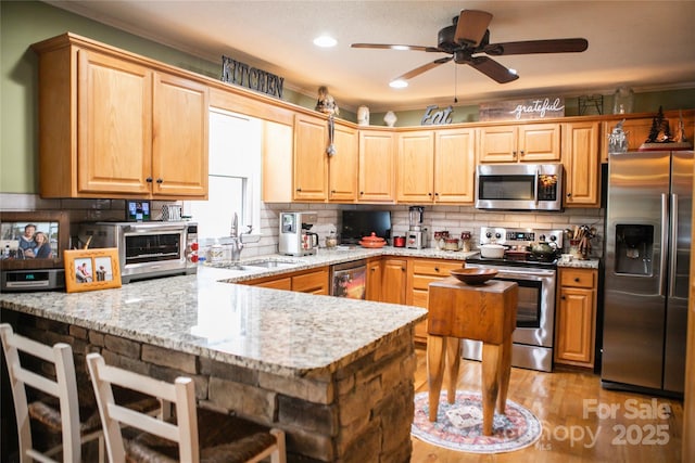 171 Shores Way, Boone, NC 28607 - kitchen with stainless steel appliances, a peninsula, light wood finished floors, backsplash, and recessed lighting