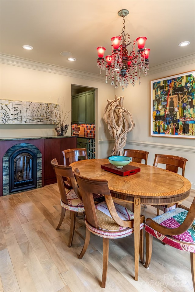 7 White Palmer Ct, Biltmore Lake, NC 28715 - dining area featuring crown molding, a glass covered fireplace, light wood-style floors, a chandelier, and recessed lighting