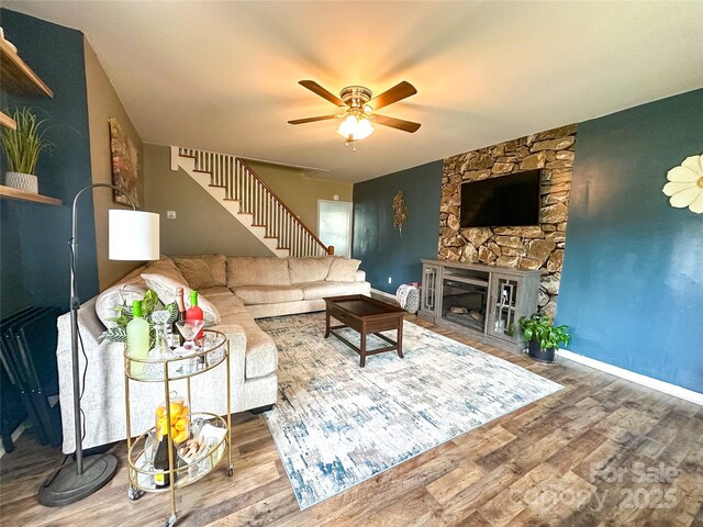 156 Spruce St, Badin, NC 28009 - living area featuring ceiling fan, wood finished floors, stairs, baseboards, and a glass covered fireplace