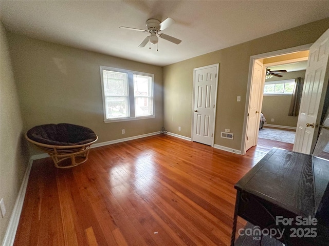 156 Spruce St, Badin, NC 28009 - unfurnished bedroom featuring baseboards, wood finished floors, and a ceiling fan