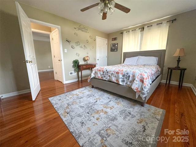 156 Spruce St, Badin, NC 28009 - bedroom with wood finished floors, baseboards, a ceiling fan, and a closet