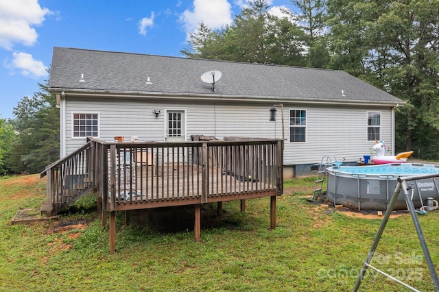 8650 Lambs Way, Connelly Springs, NC 28612 - rear view of property with a wooden deck, an outdoor pool, a yard, and a shingled roof