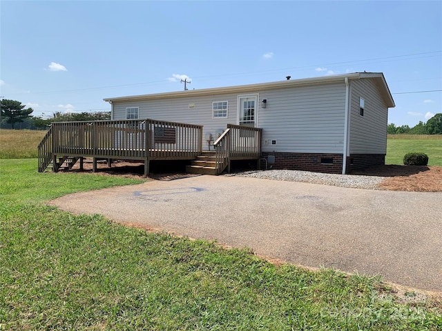 6219 Heavner Rd, Vale, NC 28168 - rear view of house with a deck, crawl space, and a lawn