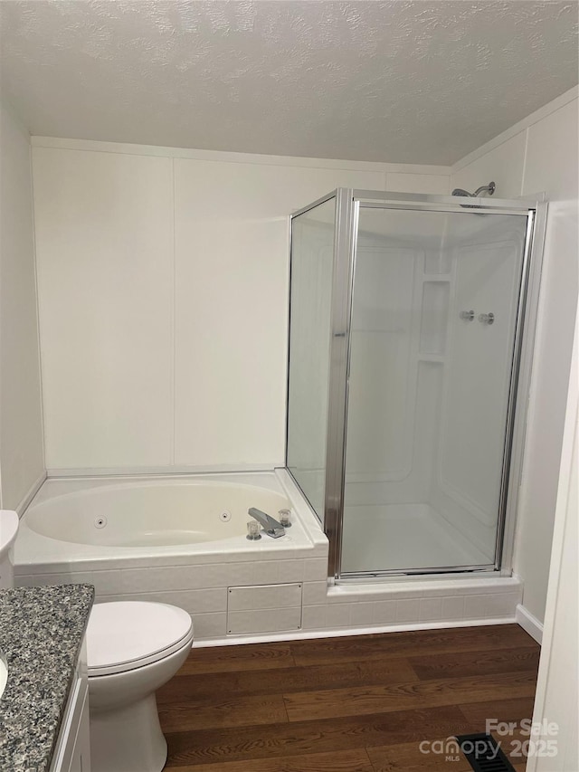 6219 Heavner Rd, Vale, NC 28168 - full bath with wood finished floors, a shower stall, vanity, toilet, and a textured ceiling