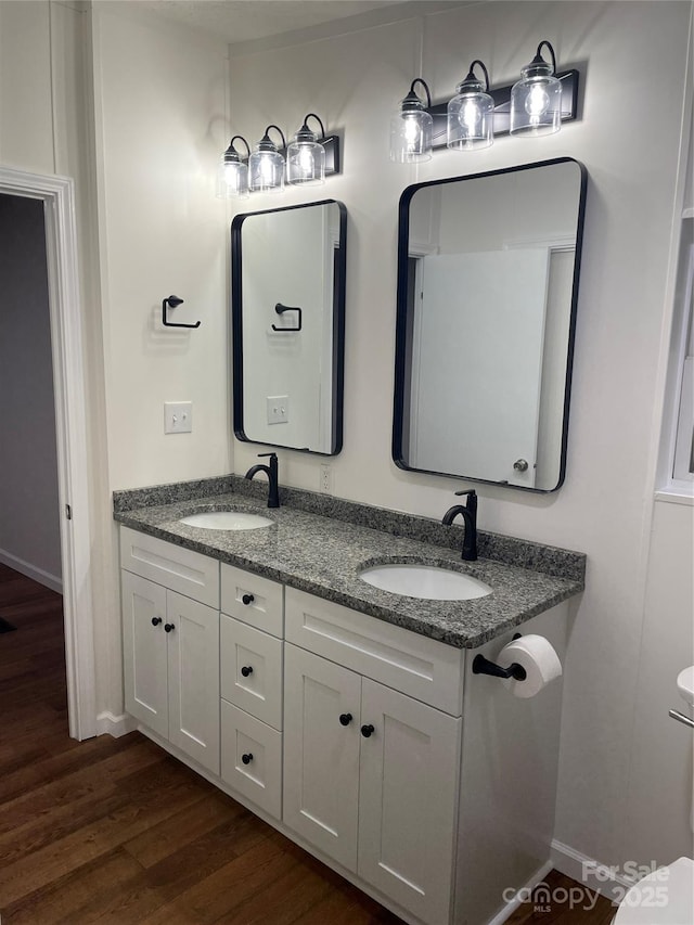 6219 Heavner Rd, Vale, NC 28168 - bathroom with wood finished floors, double vanity, toilet, and baseboards