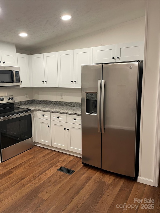 6219 Heavner Rd, Vale, NC 28168 - kitchen with stainless steel appliances, white cabinetry, dark wood-style floors, and recessed lighting