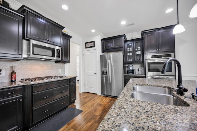 246 Bushney Loop, Mooresville, NC 28115 - kitchen featuring appliances with stainless steel finishes, a sink, ornamental molding, tasteful backsplash, and dark wood-type flooring