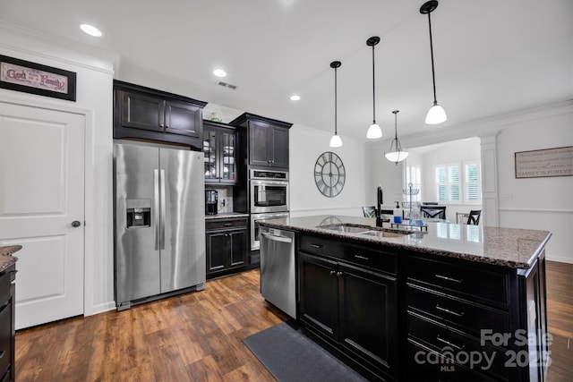 246 Bushney Loop, Mooresville, NC 28115 - kitchen with appliances with stainless steel finishes, a sink, dark cabinets, dark stone counters, and ornamental molding