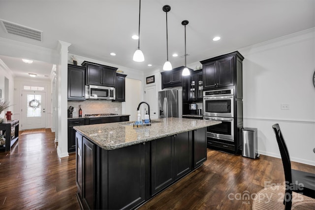 246 Bushney Loop, Mooresville, NC 28115 - kitchen featuring appliances with stainless steel finishes, a sink, crown molding, dark cabinets, and light stone counters