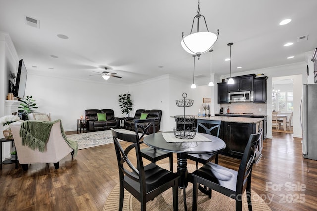 246 Bushney Loop, Mooresville, NC 28115 - dining area featuring dark wood finished floors, ceiling fan, crown molding, recessed lighting, and baseboards