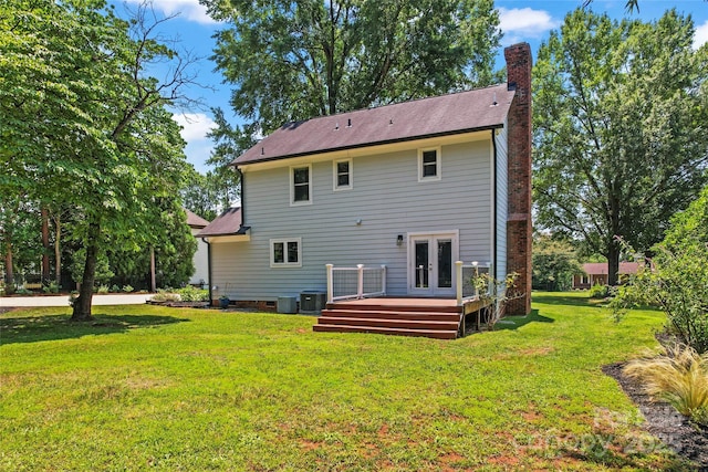 18733 Bluff Point Rd, Cornelius, NC 28031 - back of property with a chimney, a wooden deck, a yard, and french doors
