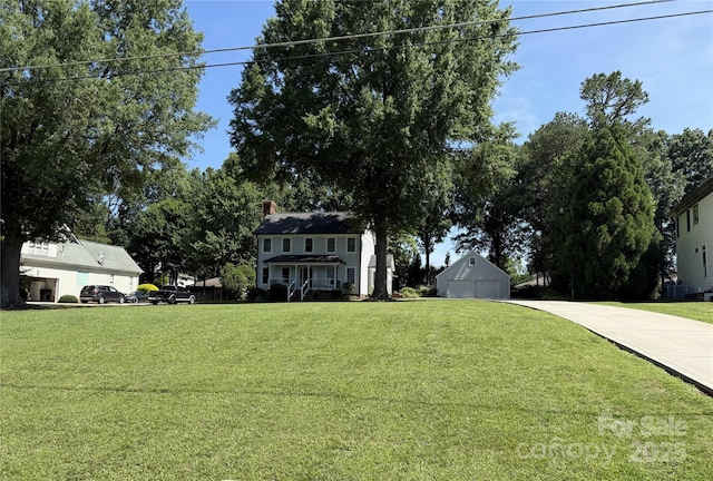 18733 Bluff Point Rd, Cornelius, NC 28031 - view of green lawn with a garage, concrete driveway, and an outdoor structure