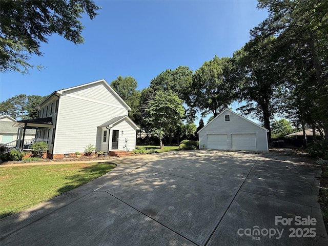18733 Bluff Point Rd, Cornelius, NC 28031 - view of home's exterior with a detached garage, an outbuilding, a lawn, and crawl space