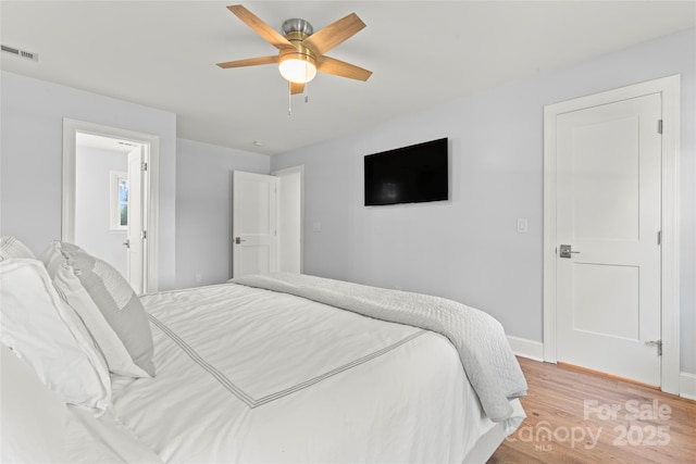 18733 Bluff Point Rd, Cornelius, NC 28031 - bedroom featuring light wood finished floors and a ceiling fan