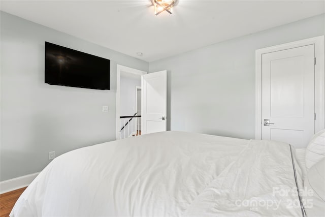 18733 Bluff Point Rd, Cornelius, NC 28031 - bedroom featuring wood finished floors and baseboards