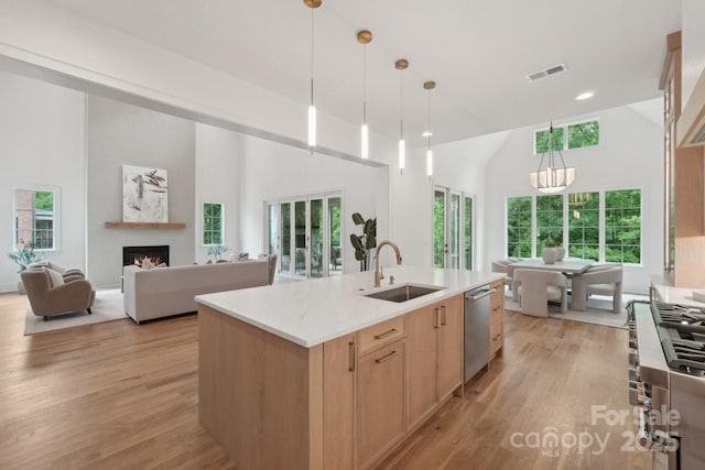 213 Crest Ct, Weddington, NC 28104 - kitchen with high vaulted ceiling, a sink, stainless steel dishwasher, light brown cabinets, and light wood finished floors