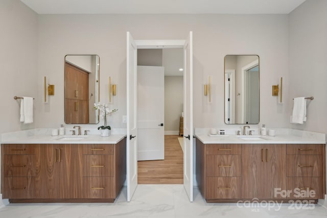 213 Crest Ct, Weddington, NC 28104 - full bathroom with two vanities, marble look tile flooring, and baseboards