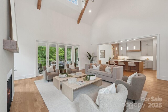 213 Crest Ct, Weddington, NC 28104 - living room featuring high vaulted ceiling, light wood-style floors, beamed ceiling, baseboards, and recessed lighting
