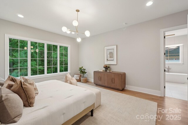 213 Crest Ct, Weddington, NC 28104 - bedroom with wood finished floors, baseboards, recessed lighting, and a chandelier