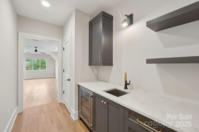 213 Crest Ct, Weddington, NC 28104 - bar featuring wine cooler, a sink, light wood-style flooring, baseboards, and ceiling fan
