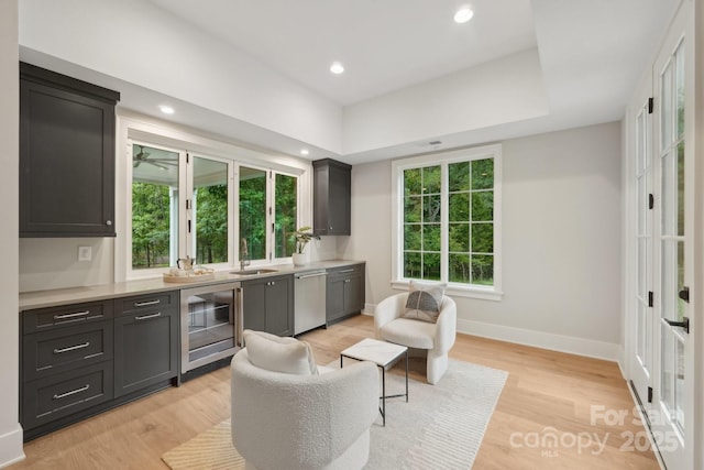 213 Crest Ct, Weddington, NC 28104 - kitchen with beverage cooler, stainless steel dishwasher, a sink, baseboards, and light countertops