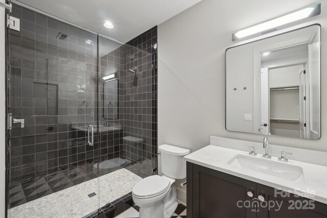 213 Crest Ct, Weddington, NC 28104 - bathroom featuring toilet, a stall shower, vanity, and recessed lighting