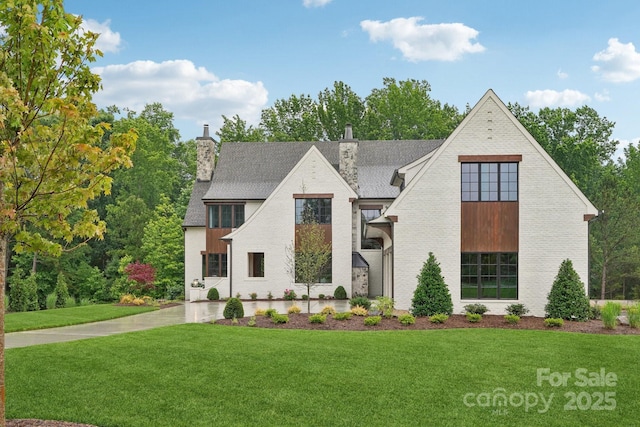 213 Crest Ct, Weddington, NC 28104 - view of front facade with a chimney, a front lawn, roof with shingles, and brick siding