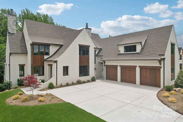 213 Crest Ct, Weddington, NC 28104 - view of front of home with a chimney, driveway, roof with shingles, an attached garage, and a front yard