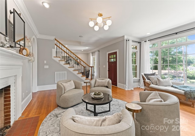 901 Hartford Ave, Charlotte, NC 28209 - living room with stairway, crown molding, a fireplace, baseboards, and wood finished floors