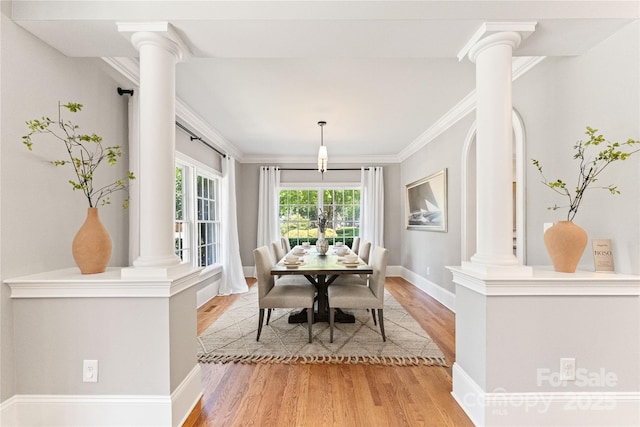 901 Hartford Ave, Charlotte, NC 28209 - dining space featuring ornate columns, light wood-type flooring, crown molding, and baseboards