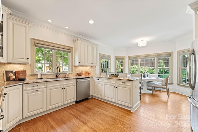 901 Hartford Ave, Charlotte, NC 28209 - kitchen with a sink, appliances with stainless steel finishes, light wood-style flooring, tasteful backsplash, and ornamental molding
