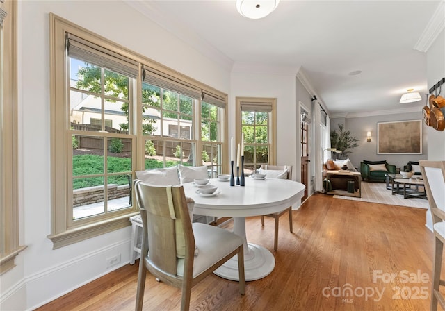901 Hartford Ave, Charlotte, NC 28209 - dining space with light wood-style floors and crown molding