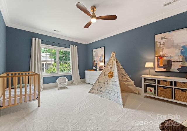 901 Hartford Ave, Charlotte, NC 28209 - bedroom with carpet flooring, baseboards, crown molding, a nursery area, and a ceiling fan