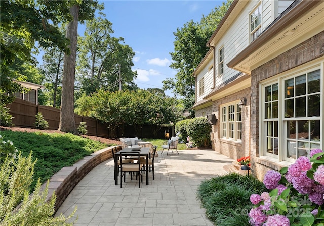 901 Hartford Ave, Charlotte, NC 28209 - fenced backyard with outdoor dining area and a patio area