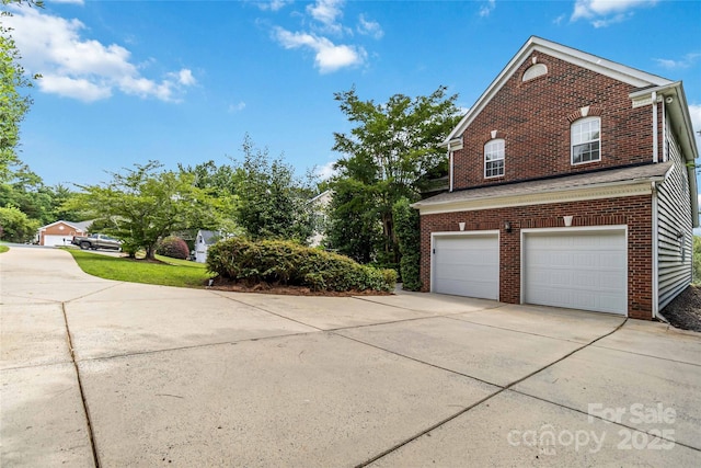 7704 Ninth Fairway Ln, Mint Hill, NC 28227 - view of side of property featuring concrete driveway, brick siding, and an attached garage