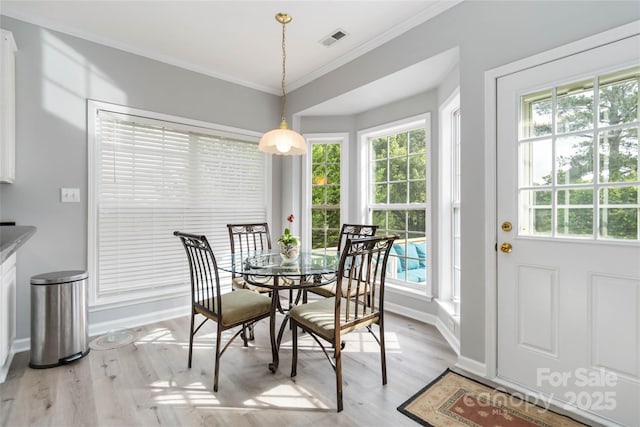 7704 Ninth Fairway Ln, Mint Hill, NC 28227 - dining space with plenty of natural light, light wood-style flooring, and ornamental molding