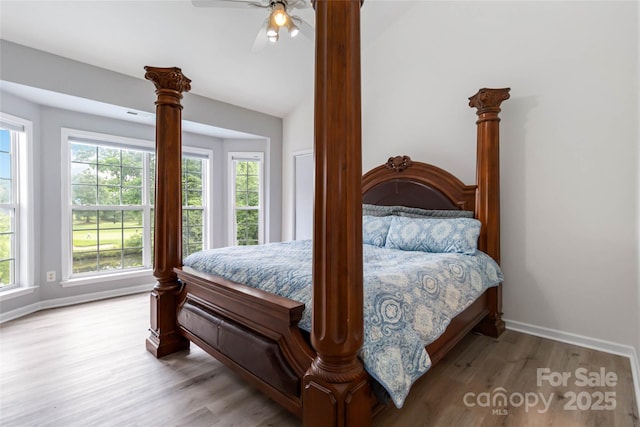 7704 Ninth Fairway Ln, Mint Hill, NC 28227 - bedroom with wood finished floors, multiple windows, ceiling fan, and vaulted ceiling