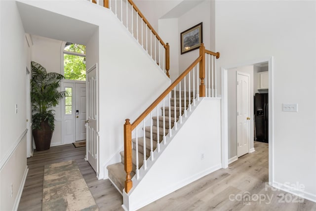7704 Ninth Fairway Ln, Mint Hill, NC 28227 - stairs featuring a towering ceiling and wood finished floors