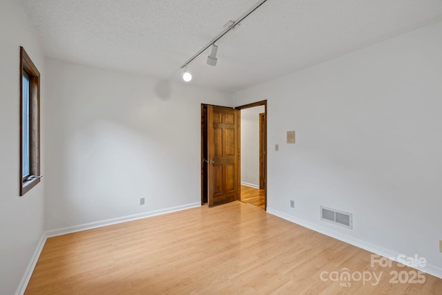 204 Woodfield Dr, Asheville, NC 28803 - unfurnished room featuring light wood-type flooring and track lighting