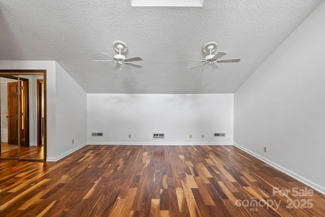 204 Woodfield Dr, Asheville, NC 28803 - additional living space with a ceiling fan, a textured ceiling, vaulted ceiling, and wood finished floors
