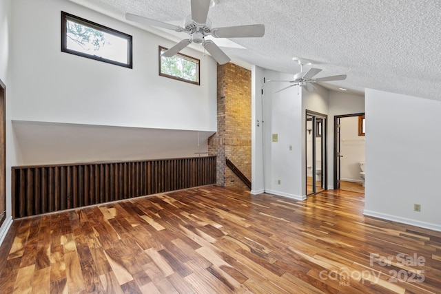 204 Woodfield Dr, Asheville, NC 28803 - unfurnished room featuring a ceiling fan, a textured ceiling, wood finished floors, and vaulted ceiling