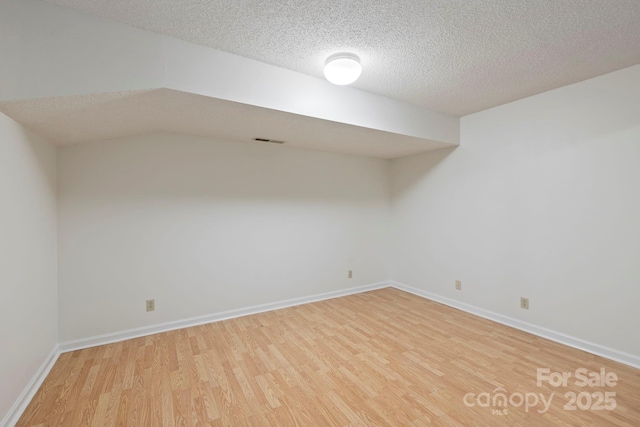 204 Woodfield Dr, Asheville, NC 28803 - finished below grade area with light wood finished floors and a textured ceiling