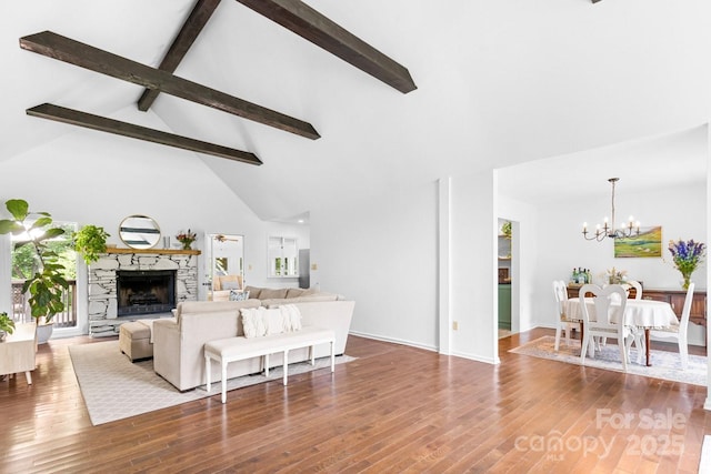 8 Briarwood Ln, Fletcher, NC 28732 - living area with beam ceiling, a chandelier, wood finished floors, a fireplace with raised hearth, and high vaulted ceiling