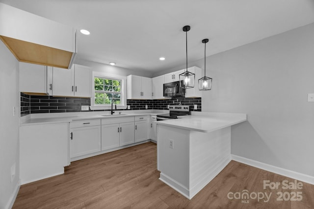 1319 Mt Gallant Rd, Rock Hill, SC 29732 - kitchen with stainless steel electric range, a sink, a peninsula, black microwave, and tasteful backsplash