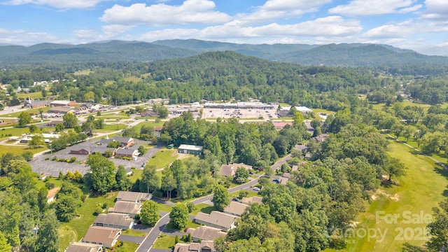 145 Fairway View Dr, Etowah, NC 28729 - aerial overview of property's location featuring a heavily wooded area, mountains, and nearby suburban area