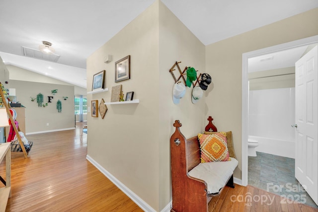 145 Fairway View Dr, Etowah, NC 28729 - hallway featuring wood finished floors, lofted ceiling, and baseboards