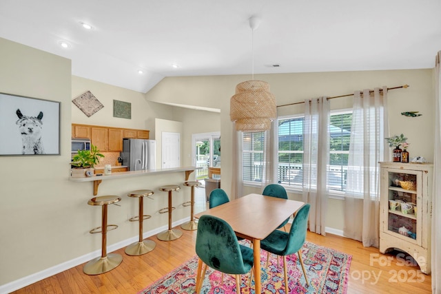 145 Fairway View Dr, Etowah, NC 28729 - dining area with lofted ceiling, light wood finished floors, baseboards, and recessed lighting