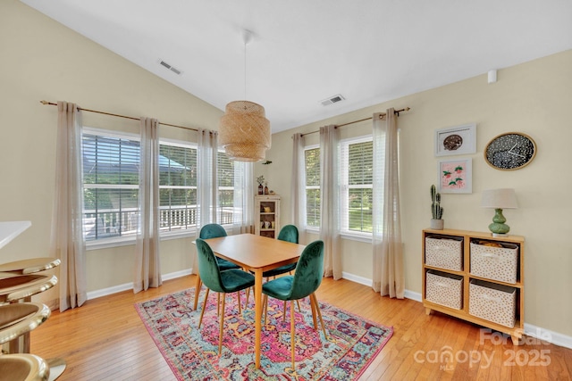 145 Fairway View Dr, Etowah, NC 28729 - dining area with light wood finished floors, vaulted ceiling, and baseboards