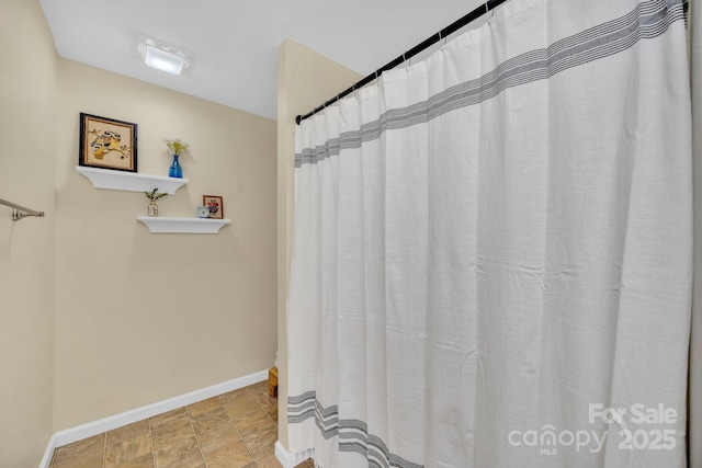 145 Fairway View Dr, Etowah, NC 28729 - bathroom featuring baseboards and stone finish floors