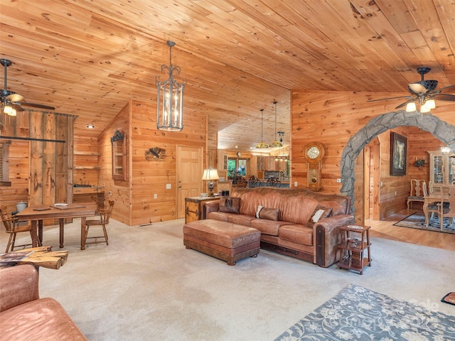 47 Tammy Dr, Maggie Valley, NC 28751 - living room featuring ceiling fan, lofted ceiling, arched walkways, carpet floors, and wooden walls